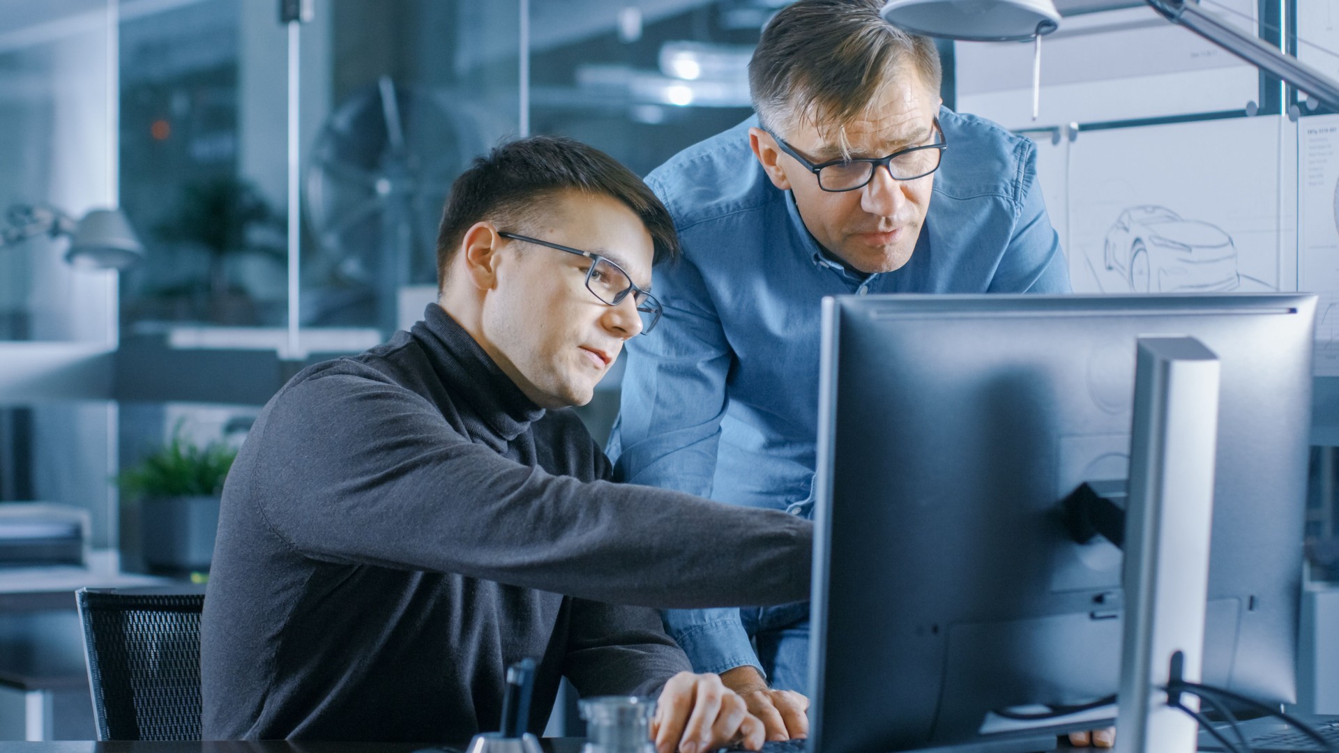 Experienced Senior Engineer Consults Young Designer about Project, They Have Discussion and Work on a Personal Computer.